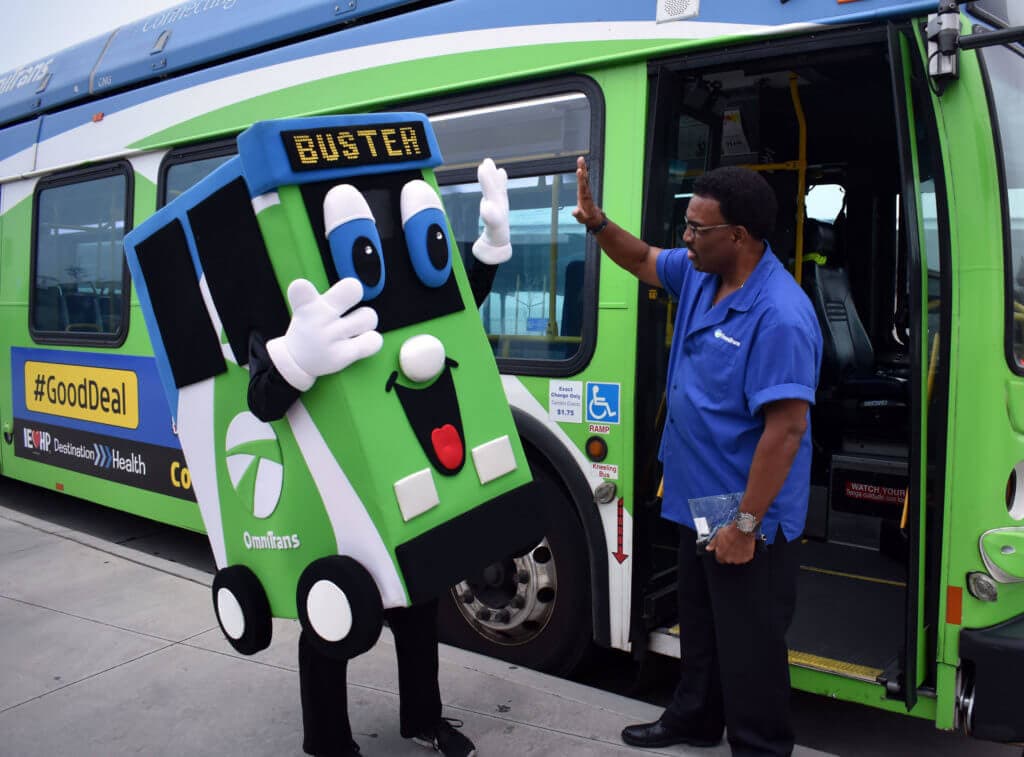 Image of Buster the Omnitrans mascot high-fiving someone