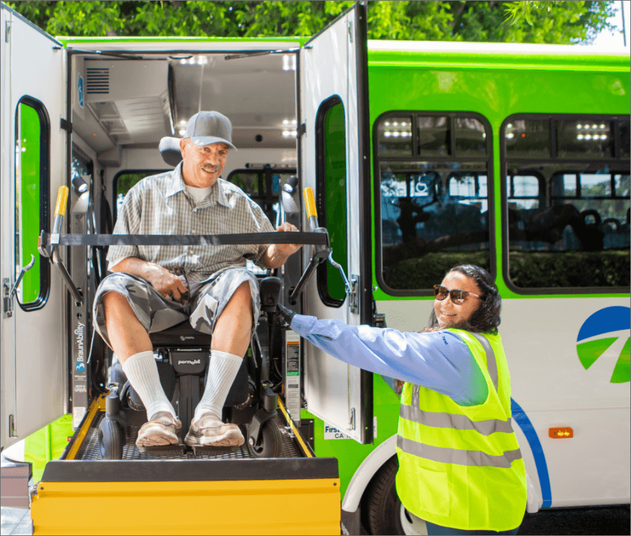 Image of man in wheelchair boarding the bus with help from Omnitrans employee