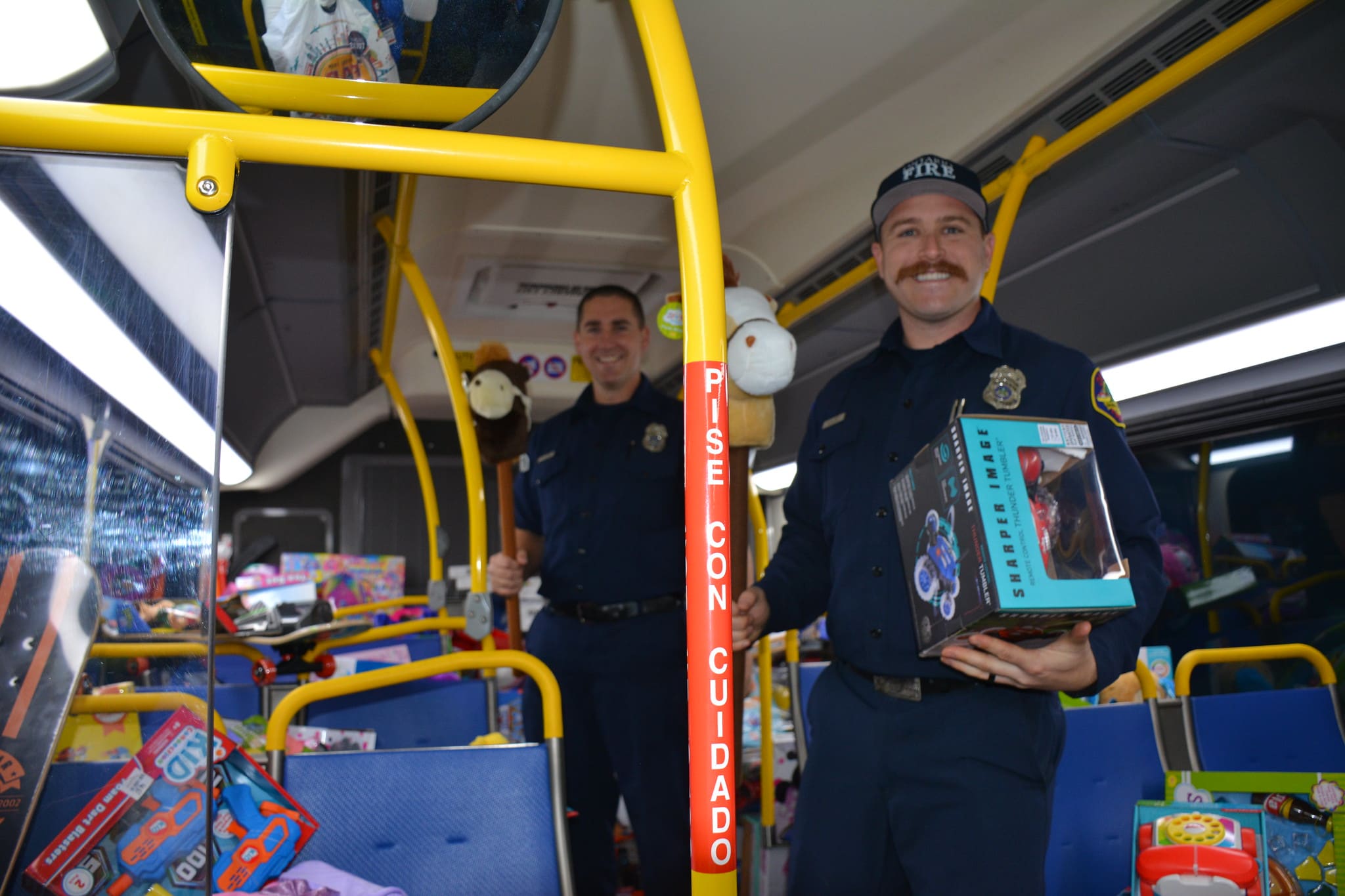 firefighters loading gift donations on bus