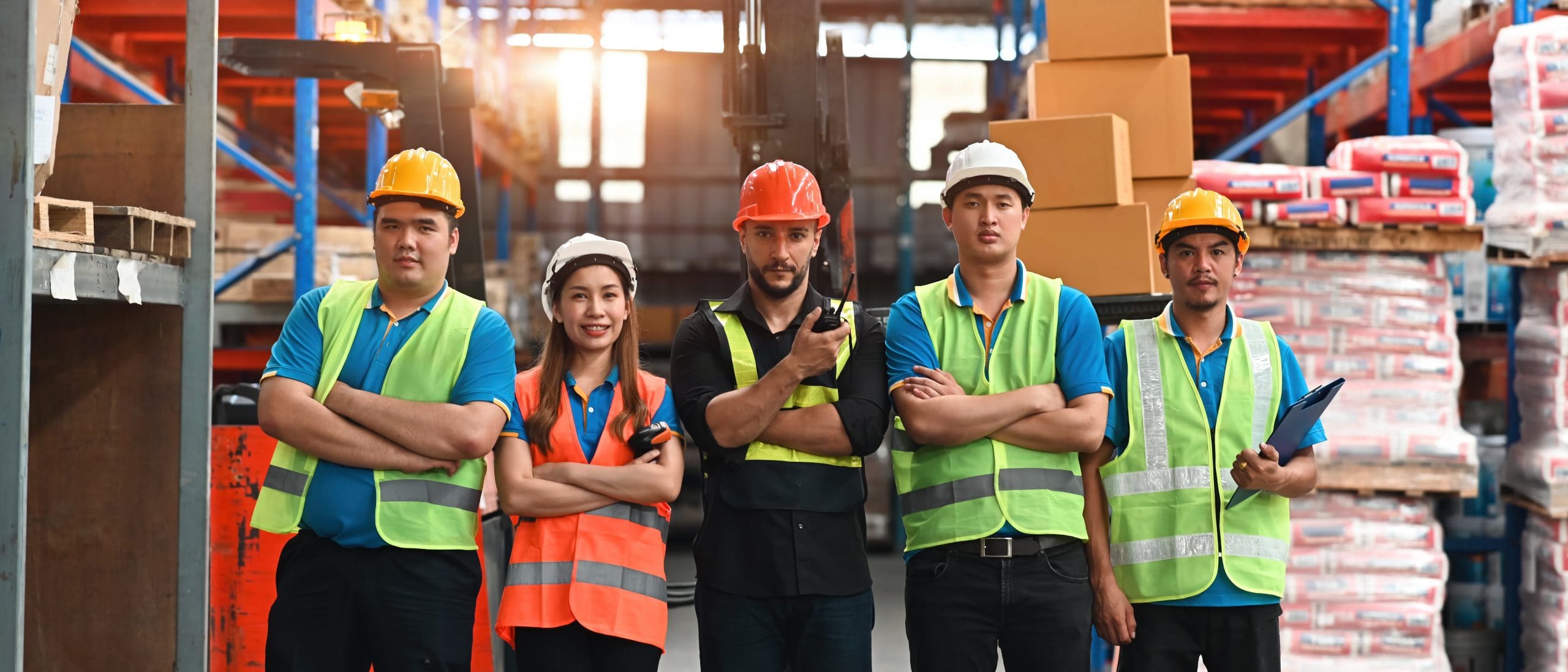Portrait of Smart and Confident Multiracial Warehouse Workers in safety wear standing in a line, Collaboration, multiracial and group of industry workers, Banner cover.